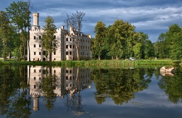 Fototapeta na wymiar Neo-Gothic style castle surrounded by an English landscape garden in Karpniki, Poland