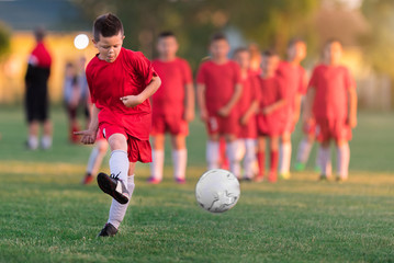 Obraz premium Kids soccer football - children players match on soccer field