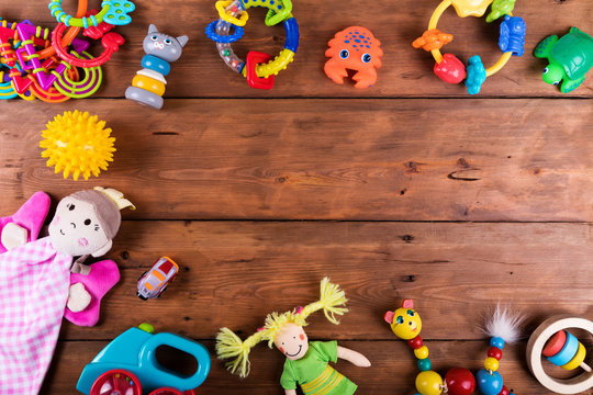 group of baby toys on wooden background with copy space. top view