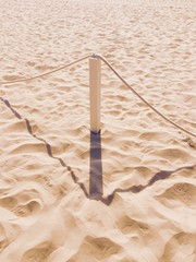 Wooden bollard on the beach (Pesaro, Italy)