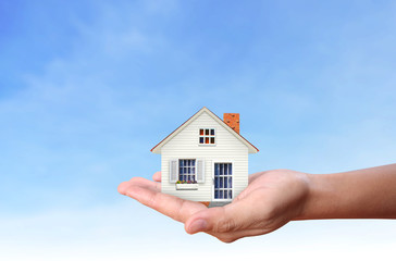 Mortgage concept by house  in hand