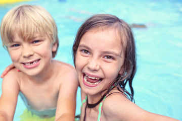 Fototapeta na wymiar hot summer day children spend in the pool