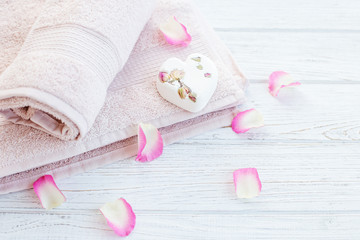 Obraz na płótnie Canvas Towels and bath salt and rose petals. Background. The concept of spa, relaxation and lifestyle.