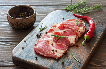 Sliced ham served on a vintage wood cutting board