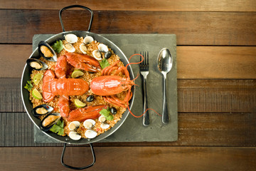 Paella with fresh lobster, clams, mussels and lime