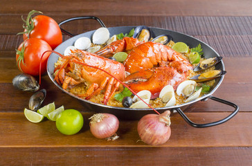 Paella with fresh lobster, clams, mussels and squid