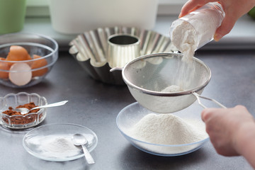 Baking cake. Next stages, following stages. We sift the flour.
