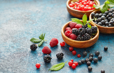 Various summer fruits in a wooden bowl