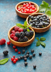 Various summer fruits in a wooden bowl