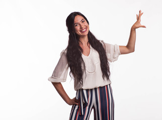 Young happy woman portrait of a confident businesswoman showing by hands on a gray background. Ideal for banners, registration forms, presentation, landings, presenting concept.