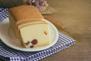 Slices of butter cake on white plate put on napkin.Homemade butter cake with dried cranberries so delicious soft and moist. Tasty pound cake or butter cake with homemade bakery concept for background.