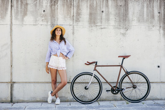 Woman standing at bike