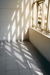 Obraz premium Concrete walls and window glasses with sun light and shadows.