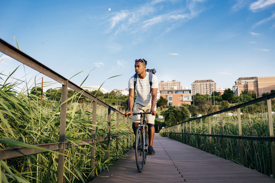 Young Man Riding Bike On Pavement