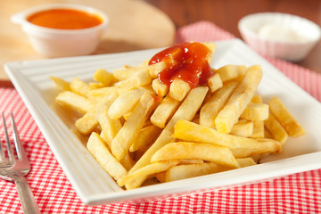 Potatoes fries in the plate isolated on white