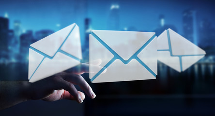 Businessman touching 3D rendering flying email icon with his finger