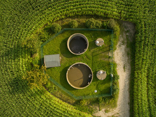 aerial view  of small sewage treatment plant betwenn corn plants fields - top view