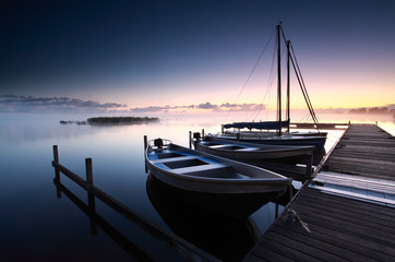 Fototapeta premium misty sunrise on lake harbor