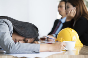 Bored businesswoman taking a nap in conference meeting room