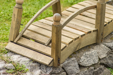 Fototapeta premium closeup of tiny wooden bridge. Garden decoration.