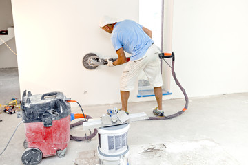 Drywall sanding. Drywall sanders, drywall sanding tool. worker using drywall sanders and polishing.