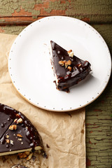Rustic cake on plate on wood backdrop