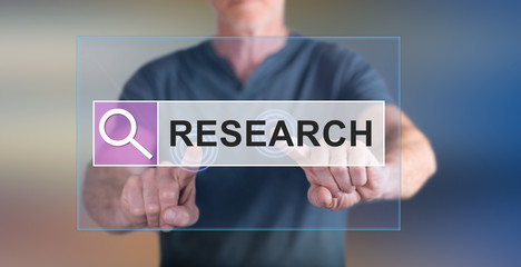 Man touching a research concept on a touch screen