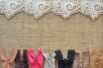 Lace at top and zippers at bottom on burlap