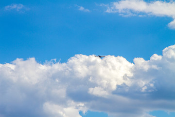 Naklejka na ściany i meble passenger airplane high in the sky in the clouds