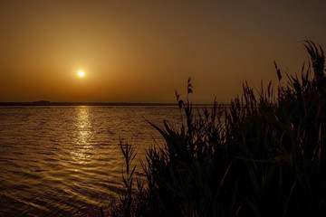 Fototapeta na wymiar Orange sunset on the lake 2