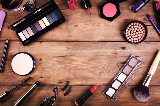 makeup cosmetics on wooden background. top view with copy space