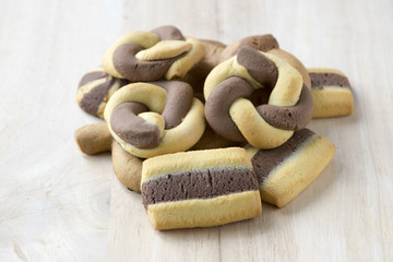 Greek dichromatic sweet cookies on wooden table cutting board, mat