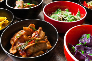 Set of different dumplings and ravioli on a wooden table.