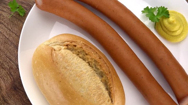 Wiener Sausage rotating on a wooden plate (not loopable; 4K)