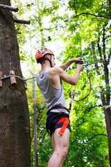 Man prepares to climb on the ropes in the park