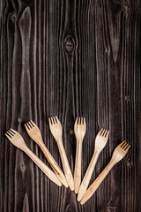wooden kitchen utensils on dark background top view mock up