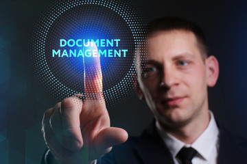 Business, Technology, Internet and network concept. Young businessman working on a virtual screen of the future and sees the inscription: Document management
