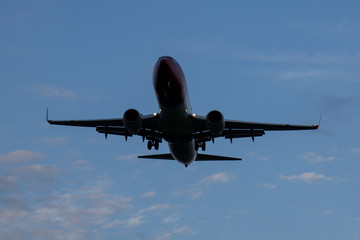 Plane lands at dusk close.