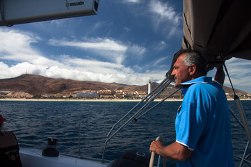 Skipper driving sailboat / Captain of the yacht