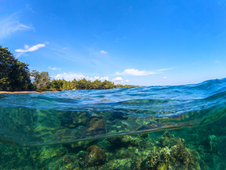 Fototapeta na wymiar Split landscape with sea and sky. Split photo with tropical island and underwater coral reef.