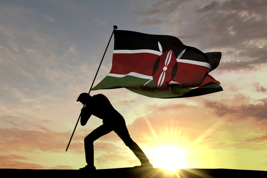 Kenya flag being pushed into the ground by a male silhouette. 3D Rendering