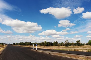 country road and white cloud blue sky background