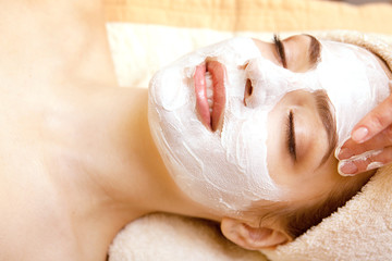 Fototapeta premium Spa salon: Beautiful Young Woman having Facial Mask