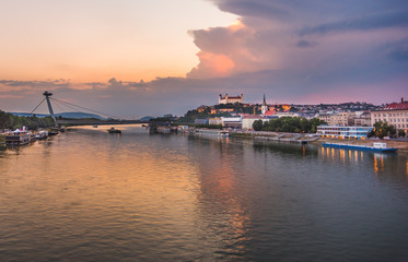 Obraz premium Cityscape of Bratislava, Slovakia at Sunset as Seen from a Bridge over Danube River Towards Old Town of Bratislava.