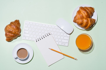Breakfast with fresh croissants and orange juice, top view