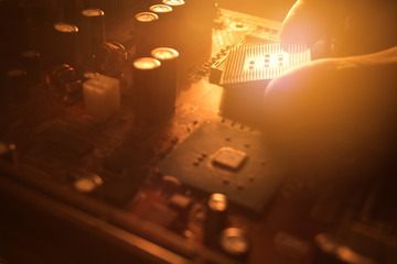 Technician plug in CPU microprocessor to motherboard socket