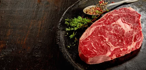 Tuinposter Piece of raw rib eye steak © exclusive-design