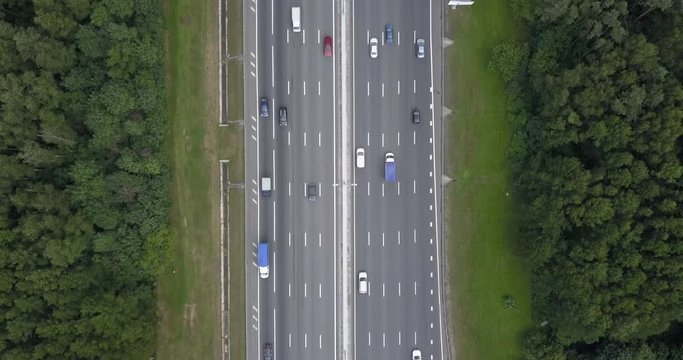 Aerial view on a wide highway with heavy traffic. Time lapse.