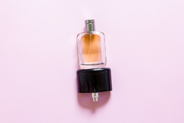 Two fragrance bottles on a pink pastel background