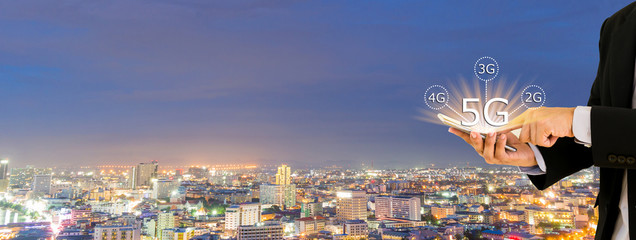 Businessmen hold a smartphone with digital pattern to view social data 5G networking concept.